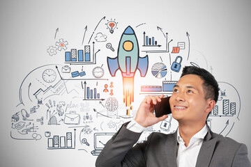 Smiling Asian man on phone, startup sketch