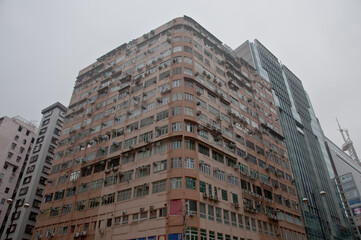 Fototapeta na wymiar HONG KONG, HONG KONG SAR - NOVEMBER 18, 2018: Crowded brown old vintage tall classical residential apartments in Central Hong Kong.