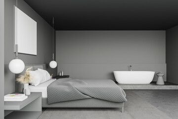 Grey bedroom with bathtub and poster, side view