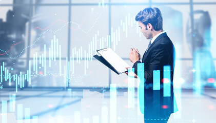 Man with clipboard in office, financial chart