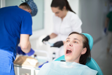 Dental treatment. Dental office. Doctor treats teeth. Woman in dentistry.