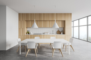 White and wooden kitchen interior with table