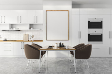 Poster in white kitchen with countertops and table