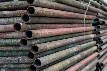 Scaffolding stacked with a stack for storage. Equipment for high-altitude construction work. Steel framework from scaffolding
