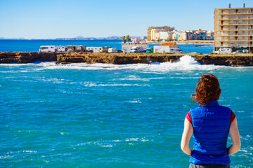 Fototapeta na wymiar Tourist woman on sea cliffs in Spain