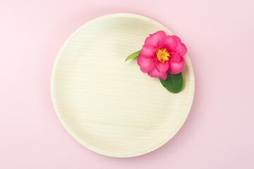 Natural disposable plate with pink tropical flower