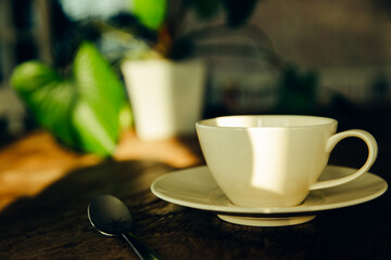 A white coffee mug on a wooden office desk