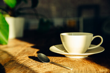 A white coffee mug on a wooden office desk