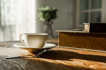 A white coffee mug on a wooden office desk