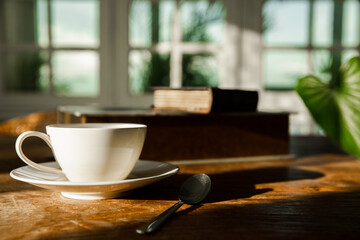A white coffee mug on a wooden office desk
