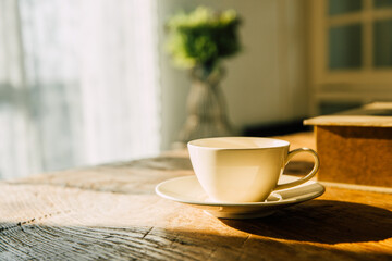 A white coffee mug on a wooden office desk