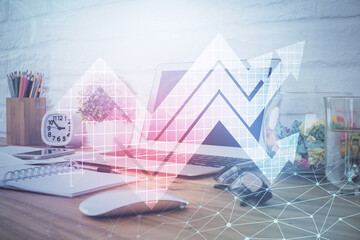 Computer on desktop with point up arrows hologram. Double exposure. Concept of success.