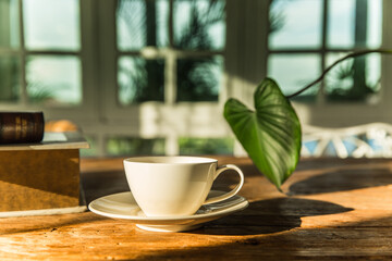 A white coffee mug on a wooden office desk