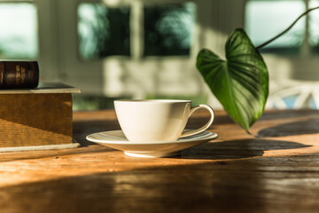 A white coffee mug on a wooden office desk