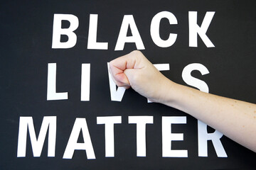 fist beats on words black lives matter on black background, concept