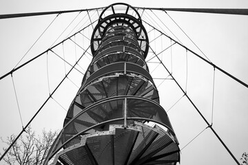 Metal observation tower supported by wire cables. 