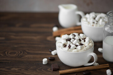 two cups of black coffee with chocolate and marshmallows