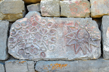 Ancient stone with picture. Wall of Kala-Koreysh fortress. Dagestan, North Caucasus, Russia.