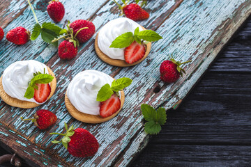 tasty strawberry dessert on a slate board on a turquoise wooden table