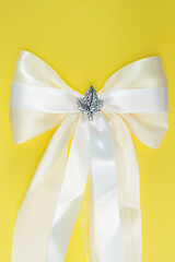 golden bow on yellow background