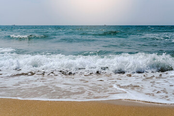 A beach and sea waves.