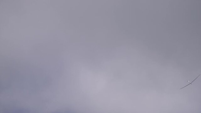 A sailplane in the sky among the clouds, glider leisure