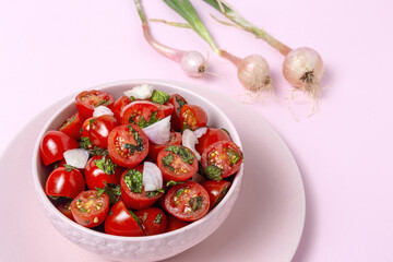 Homemade cherry tomato salad with fresh onions, mint, olive oil and salt