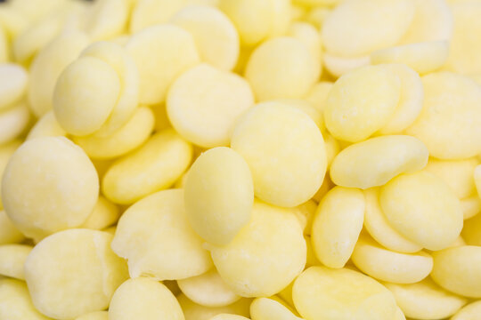 close-up of yellow cocoa butter pieces - theobroma oil