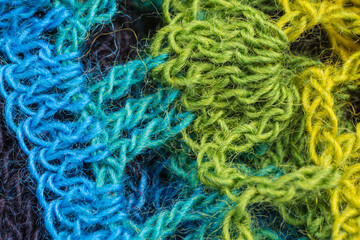 handmade multicolor crochet background with double crochet stitches, triple crochet stitches and chain stiches