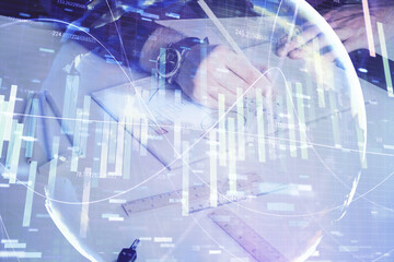 Double exposure of hands and notepad with business icons.