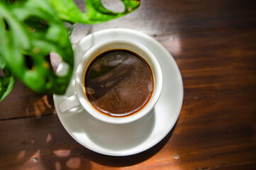 Black coffee on the wooden table, soft focus image