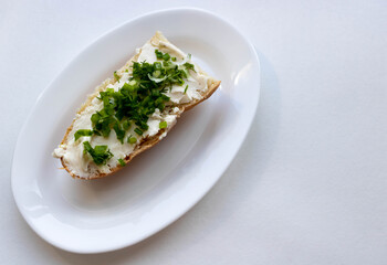 Sandwich of melted cheese with ham and onion and dill greens.Healthy food concept
