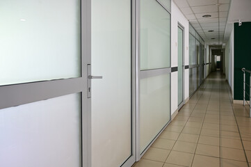 Photo of a corridor with white doors inside the building.