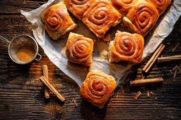 Homemade cinnamon rolls on a wooden  rustic table, top view
