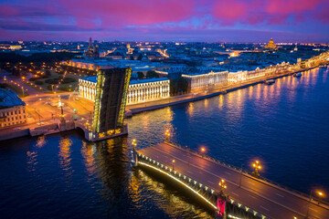 Fototapeta premium Saint Petersburg. Russia. Trinity bridge in the night city. Raised bridge in the night St. Petersburg. Panorama of evening Petersburg. Cities of Russia top view. City night lights. Traveling in Russia