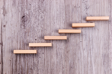 Step by step. Wooden stairs symbolize growth. Career development