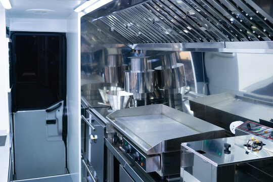 Small restaurant kitchen. Empty restaurant kitchen with new equipment. Industrial electric frying pan and deep fryer. Concept - sale of restaurant equipment. Cafe is empty due quarantine. Bankruptcy