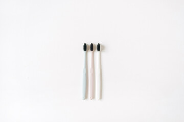 Toothbrushes on white background. Flat lay, top view oral care, dental hygiene concept.