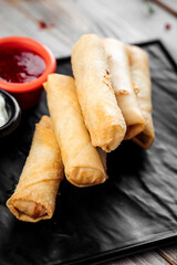 Fried spring rolls with cheese filling red sauce