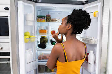African Woman Think About Food Near Fridge