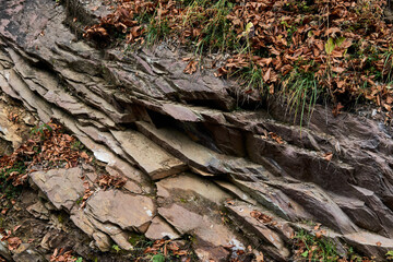 nature, adventure and tourism concept - stone surface of mountains close-up