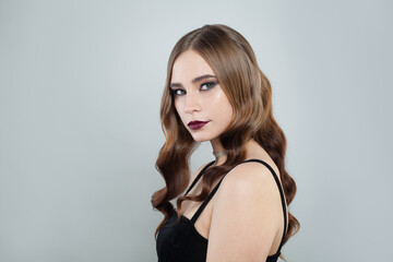 Fototapeta premium Beautiful girl with brown curly hair on white