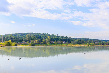 Summer landscape sunrise on the lake . Morning light. Reflection in the water of the lake. Mirror lake. Journey. Outdoor recreation.