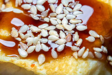 Background with a Japanese dish of rice, caviar and sesame seeds with a strong increase in soft focus