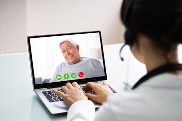 Fototapeta na wymiar Doctor Talking To Patient Through Video Chat On Laptop