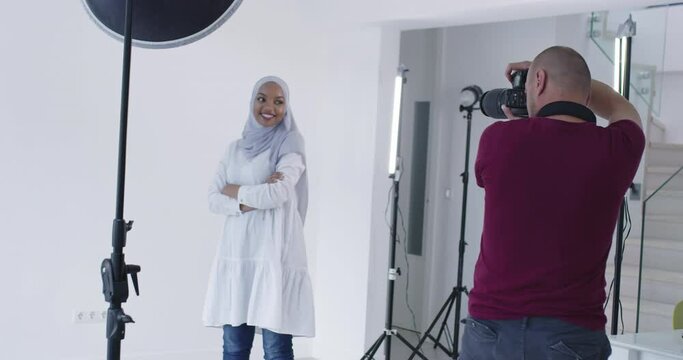 Photographer in photo studio shooting traditional muslim model