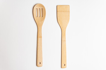 .bamboo cutlery on a white salted background. bamboo spoon and spatula on a white surface.