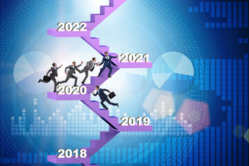 Businessman climbing stairs on yearly basis