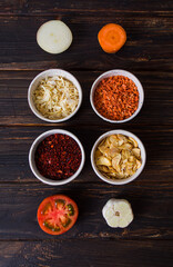 Different ground condiments with vegetables, their components