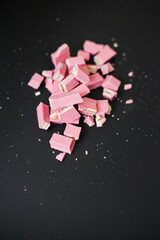 pink chocolate laying  on the dark background